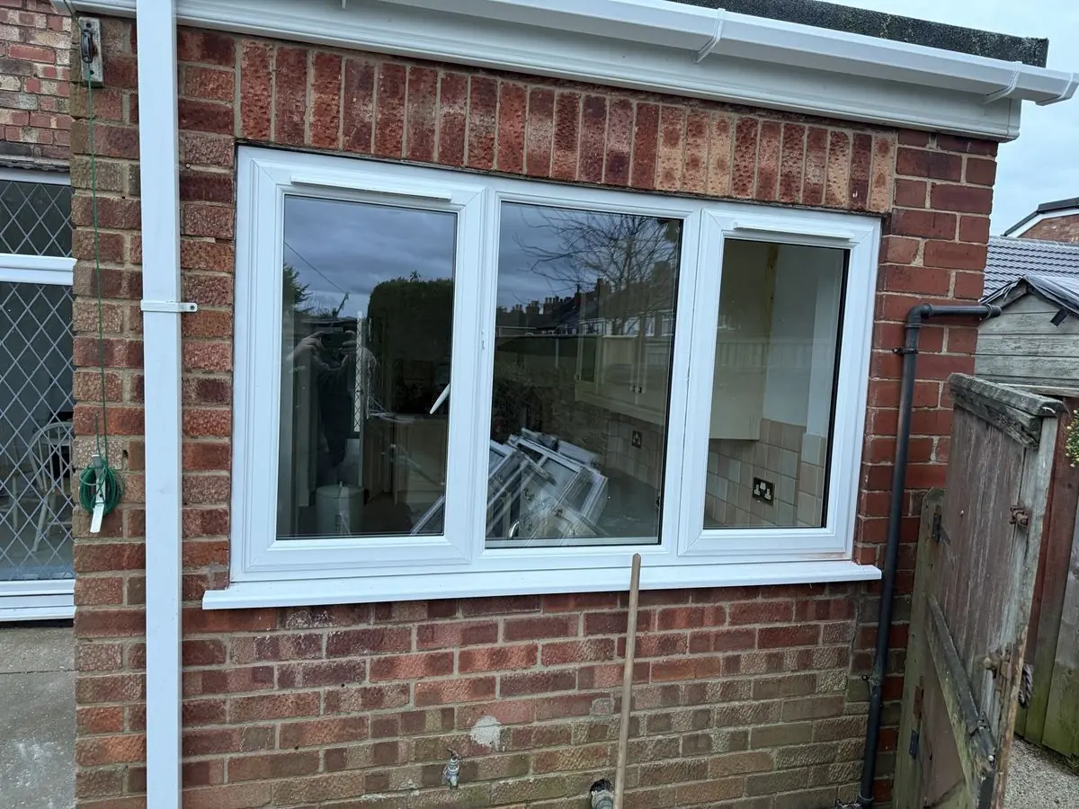 Single-storey brick extension with new white windows