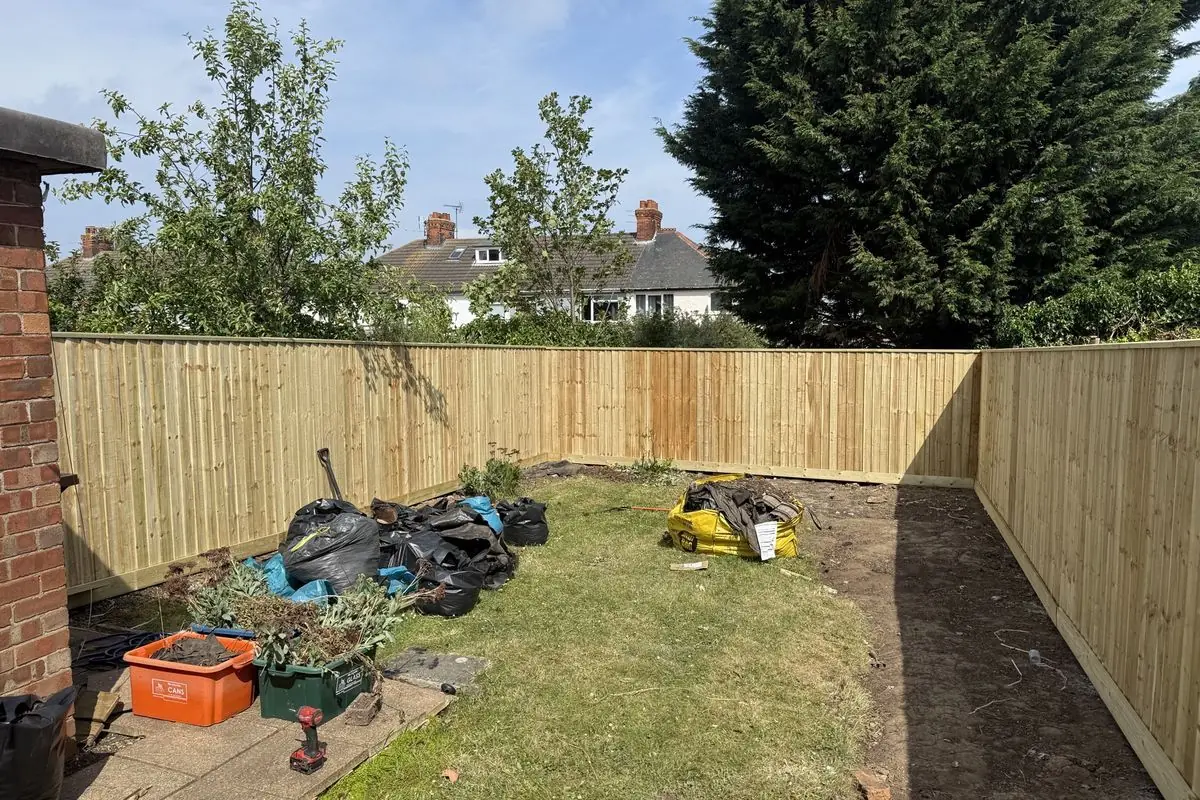 The same garden mid-works, cleared with rubble bags and bare soil
