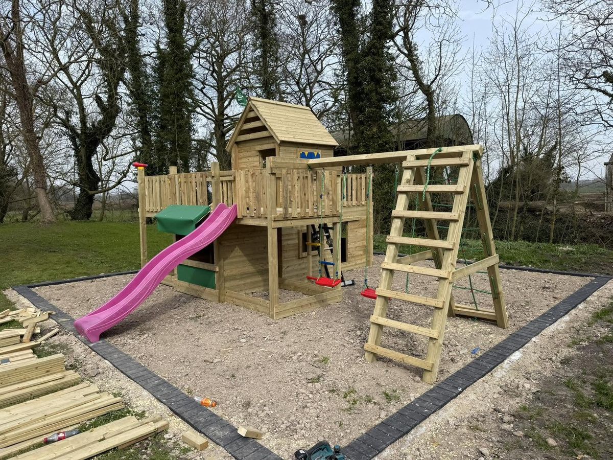 Bespoke pressure-treated timber play frame with tower, slide and swings