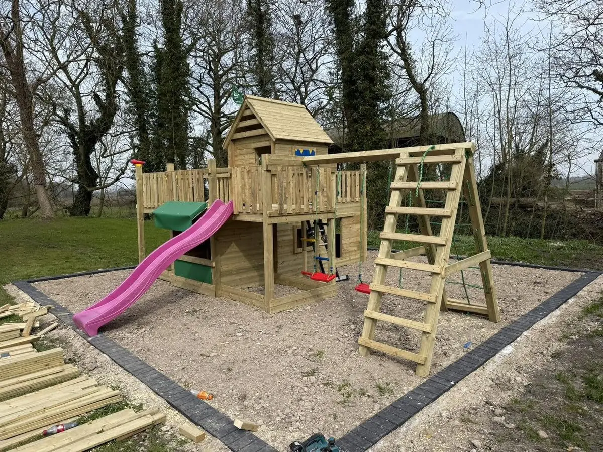 Bespoke pressure-treated timber play frame with tower, slide and swings